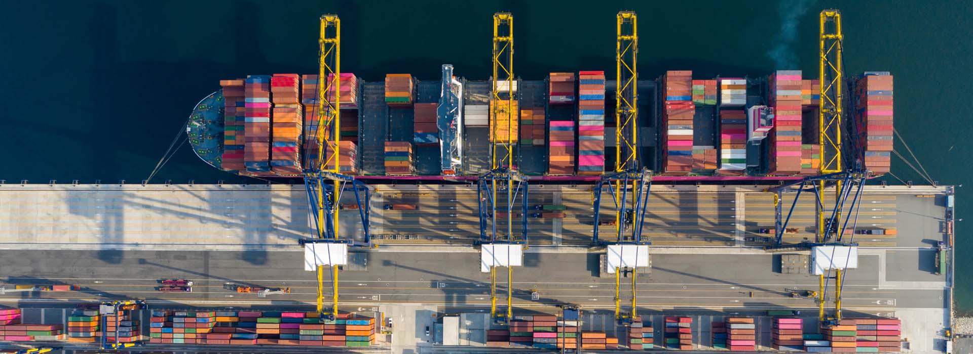Photo of a container ship in the harbour, photographed from above